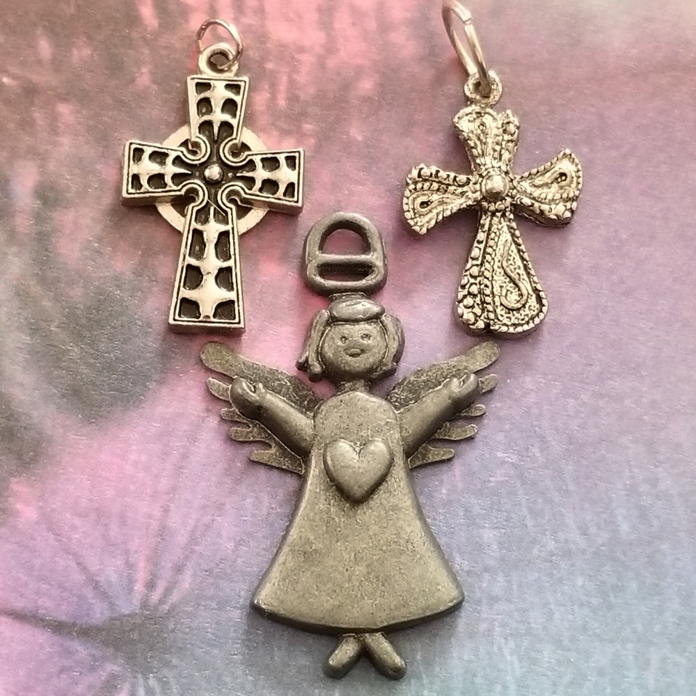 Three pendant charms angel and 2 crosses silver tone